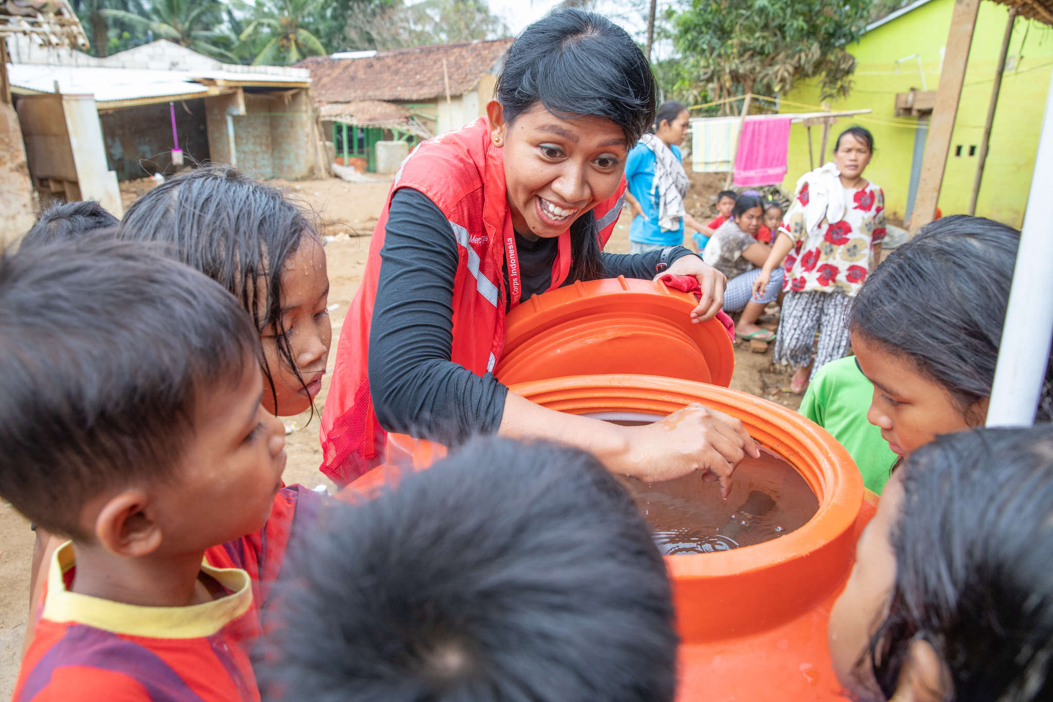 A group of young people receive clean water.