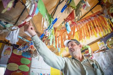 Ahmad stands under the colorfully decorated ceiling