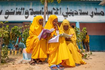 Girls study in front of their school outside mogadishu where displaced children transition from temporary schools into permanent ones.