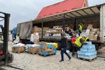 People unloading supplies.