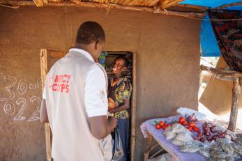 A project officer for mercy corps in the yumbe district, talks to a south sudanese refugee and participant in the dreams program.