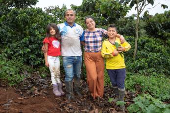 A farmer and land owner poses for a picture with their family.