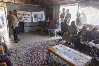 Drc protection teams facilitate an explosive ordnance risk education session with community members at a displacement site, sharing practical information on identifying and avoiding explosive hazards. 