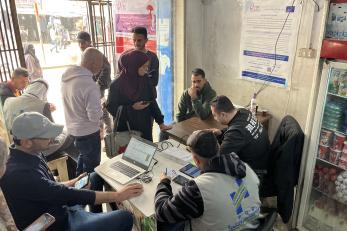 People redeem multi-purpose cash assistance at a vendor location in gaza city.