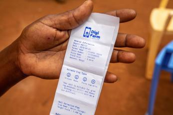 Hand holding a digi-farm receipt