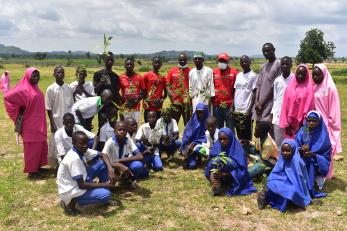 In Kwaya Kusar, students plant seedlings as part of a climate change awareness program. 
