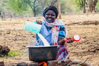 A person skimming milk.