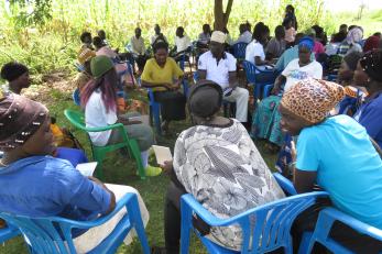 A group of people meeting in small groups.