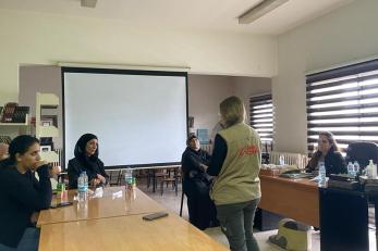 A group of people attending a meeting.