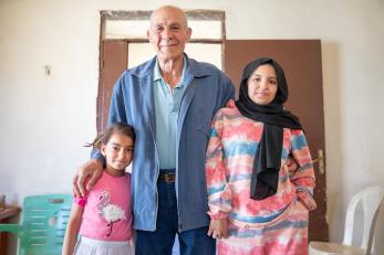 Three members of a family posing together.