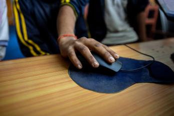 A hand holding a computer mouse.