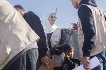 Image of Mercy Corps aid worker among a group of other aid workers.