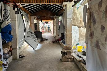 Photo of an covered outdoor walkway that leads to Club International Rotary in Haiti, which is housing IDPs.