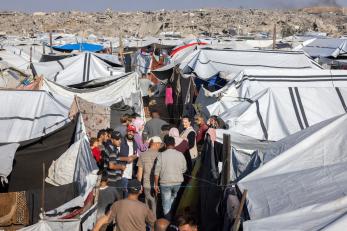 Scene of community members, among tents, in a displacement camp in northern Gaza.