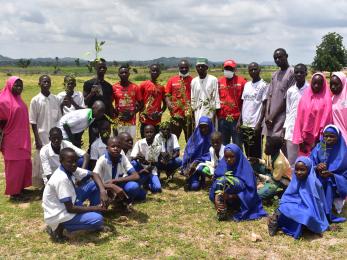 In kwaya kusar, students plant seedlings as part of a climate change awareness program. 
