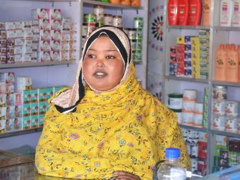 A  business owner tending to their shop.