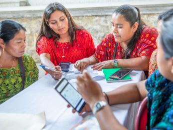 Farmers sitting at a table during a workshop.