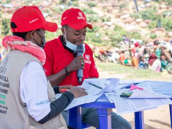 The safer humanitarian team calls participants during a multi-purpose cash distribution.