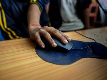 A hand holding a computer mouse.